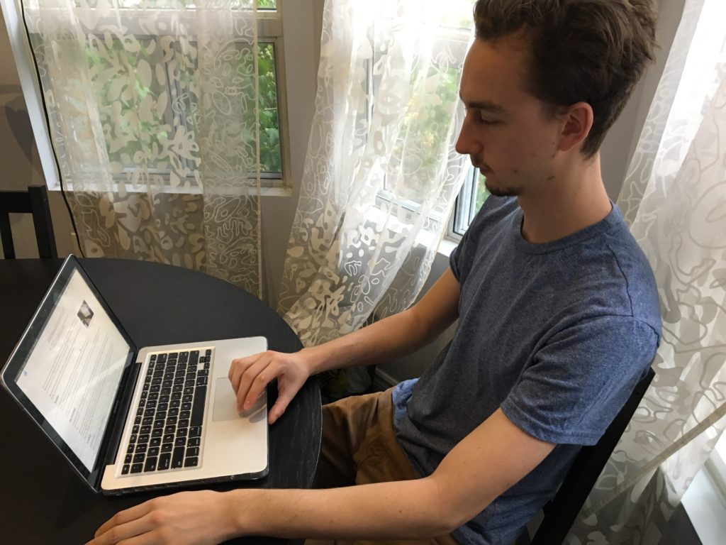 Kevin in front of my laptop looking at one of my portfolio projects on my site.