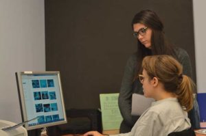 Conducting a usability test with the user sitting in front of the screen and me observing